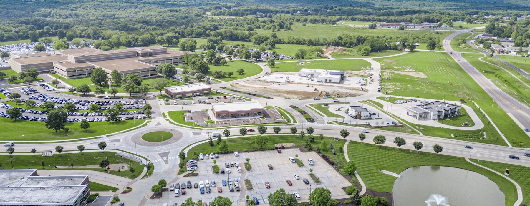 an aerial view of a roundabout with cars and buildings