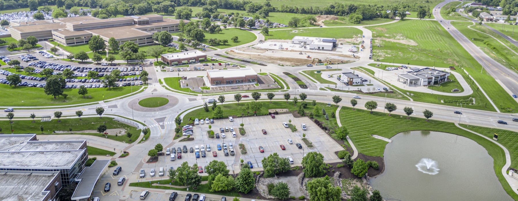 an aerial view of a roundabout with cars and buildings