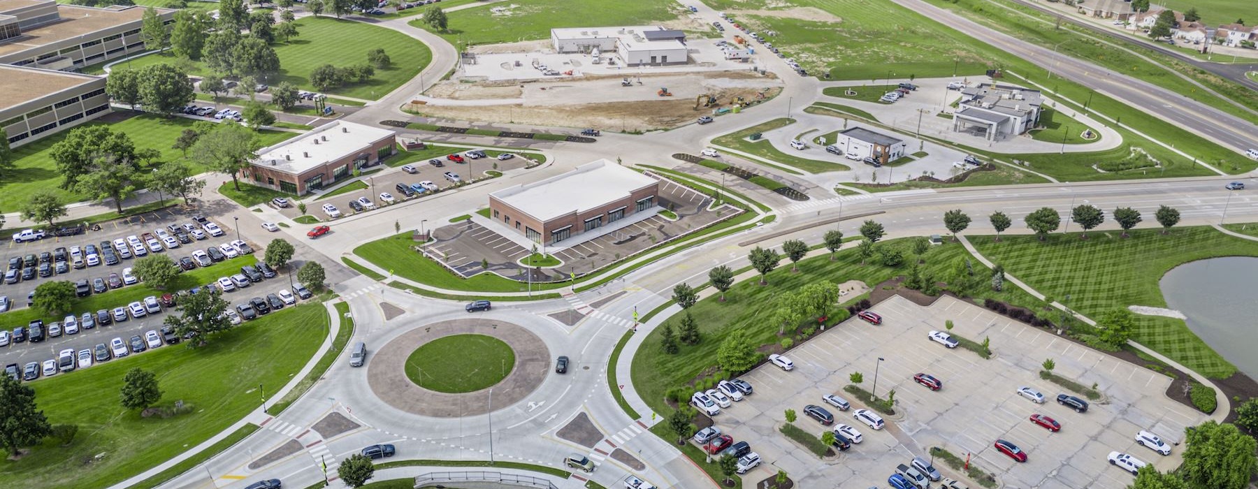 an aerial view of a roundabout with cars and buildings