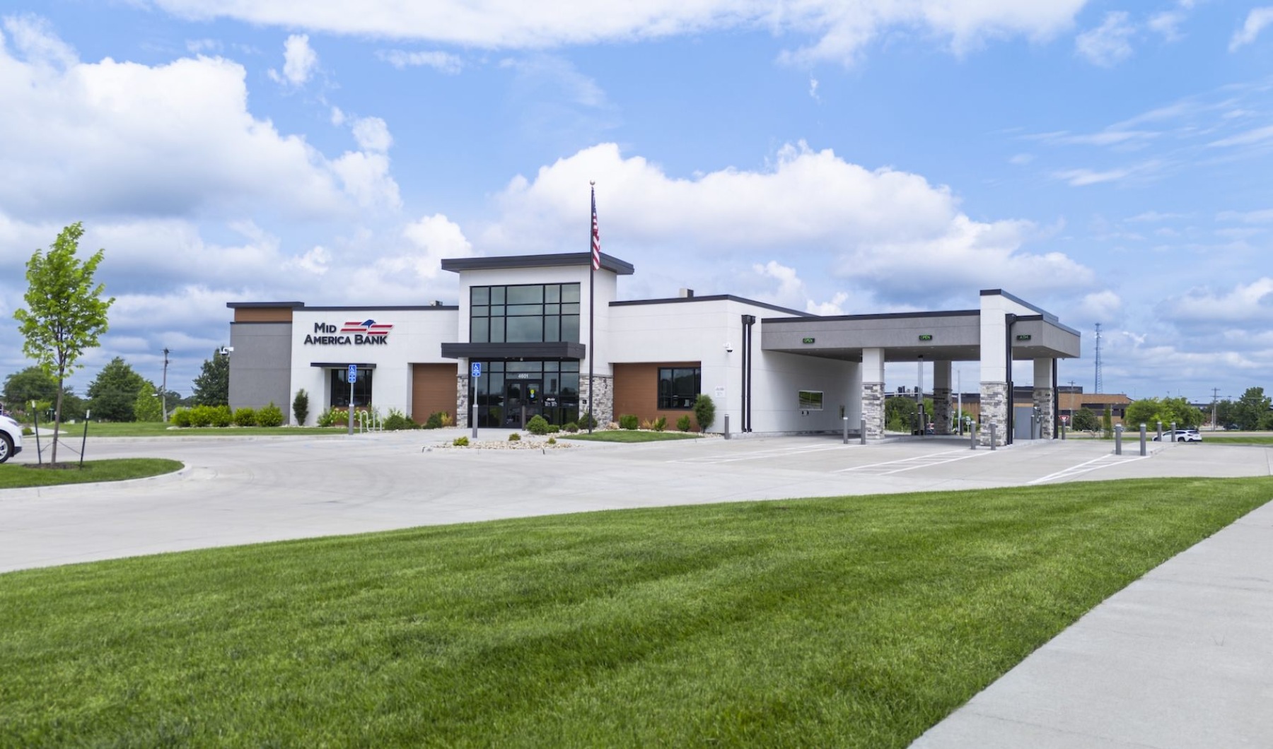 a white building with grass